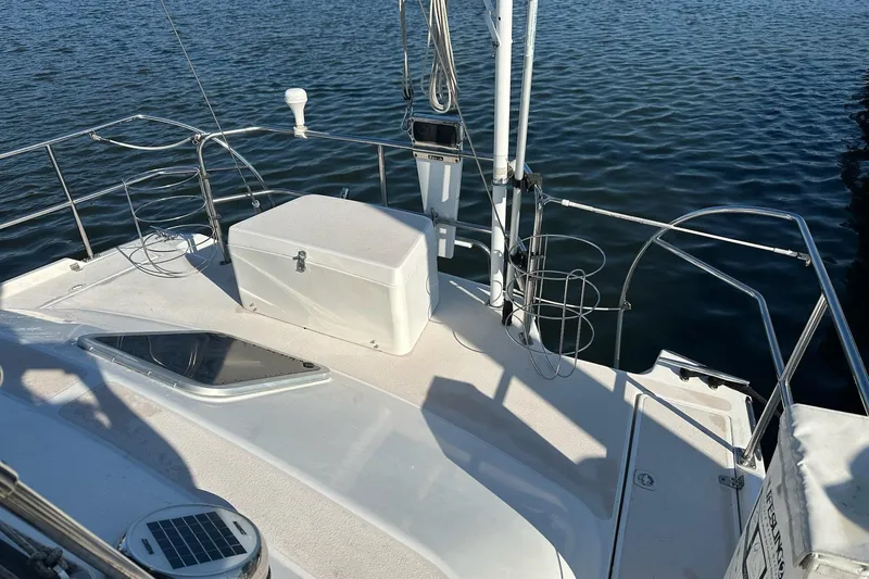 Slide: The Image of 1997 Catalina Morgan 38 sailboat deck with storage box, railing, and ocean view. - 31