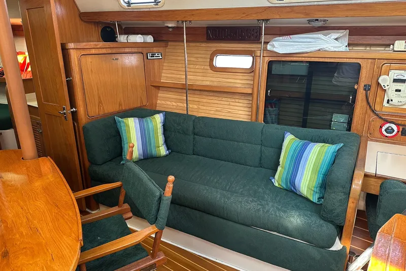 Slide: The Image of Cozy interior of 1997 Catalina Morgan 38 sailboat with green sofa and striped pillows. - 35