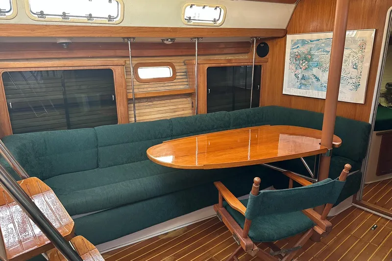 Slide: The Image of Interior of 1997 Catalina Morgan 38 sailboat with green seating and wooden table. - 36