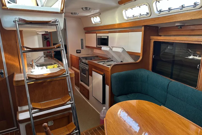 Slide: The Image of Interior of 1997 Catalina Morgan 38 sailboat with kitchen and seating area. - 37