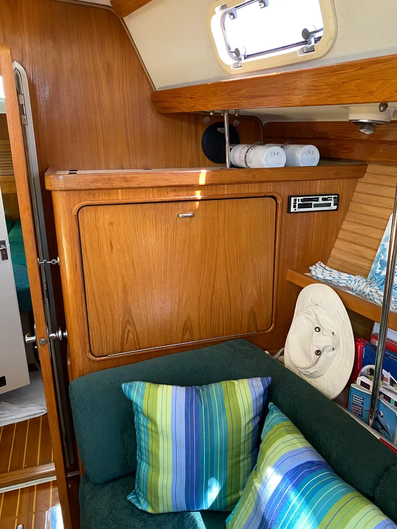 Slide: The Image of Cozy interior of 1997 Catalina Morgan 38 sailboat with colorful cushions and wooden cabinetry. - 41
