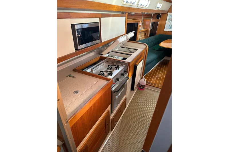 Slide: The Image of Interior of 1997 Catalina Morgan 38 yacht with kitchen and seating area. - 44