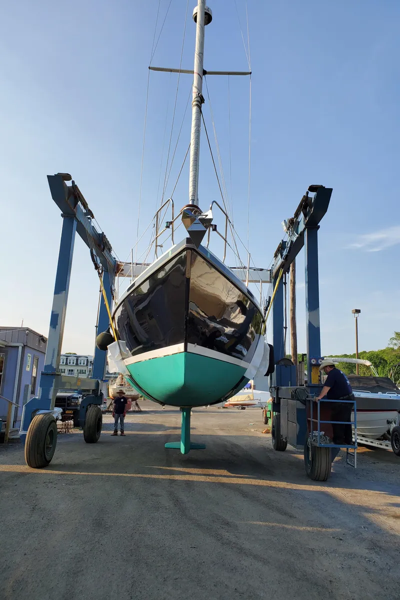 Slide: The Image of 1997 Catalina Morgan 38 sailboat in dry dock, supported by a boat lift. - 5