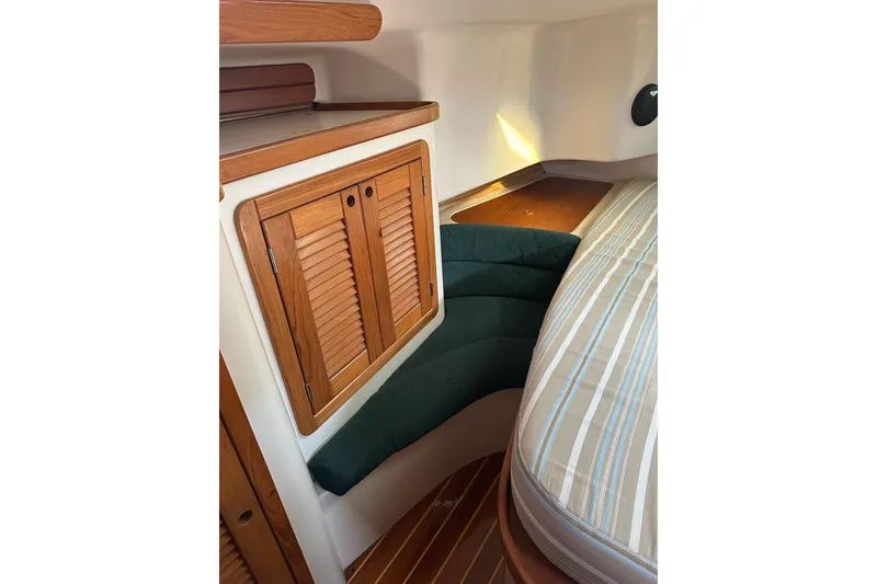 Slide: The Image of Interior of 1997 Catalina Morgan 38 sailboat with wooden cabinetry and cushioned seating. - 50