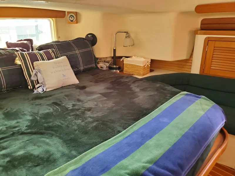 Slide: The Image of Cozy cabin interior of 1997 Catalina Morgan 38 sailboat with plush bedding and nautical decor. - 53