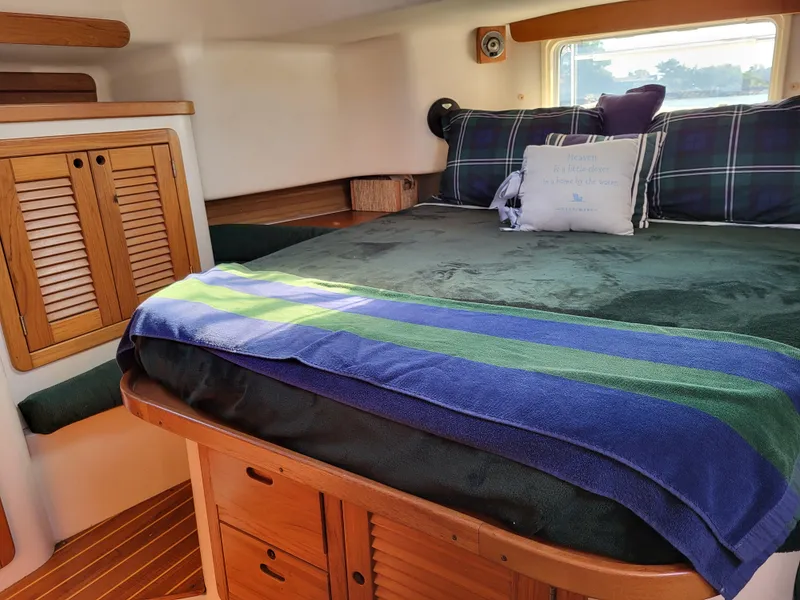 Slide: The Image of Cozy cabin interior of 1997 Catalina Morgan 38 sailboat with bed and wooden storage. - 54