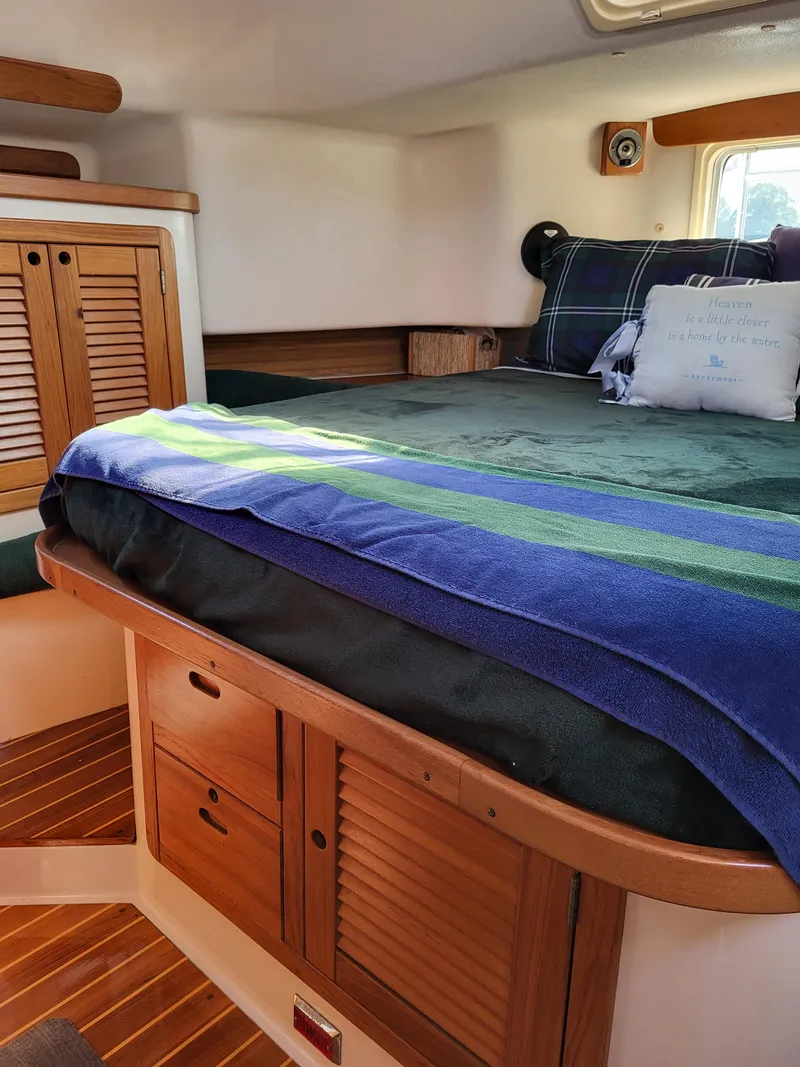 Slide: The Image of Cozy cabin interior of 1997 Catalina Morgan 38 sailboat with wooden storage and bed. - 55