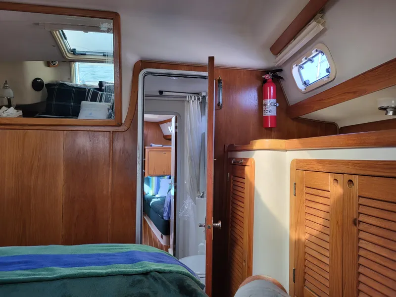 Slide: The Image of Interior of 1997 Catalina Morgan 38 sailboat with wood paneling and a fire extinguisher. - 56