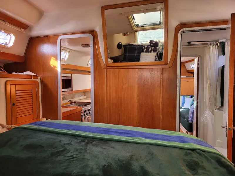 Slide: The Image of Interior of 1997 Catalina Morgan 38 sailboat with wood paneling and cozy cabin layout. - 57