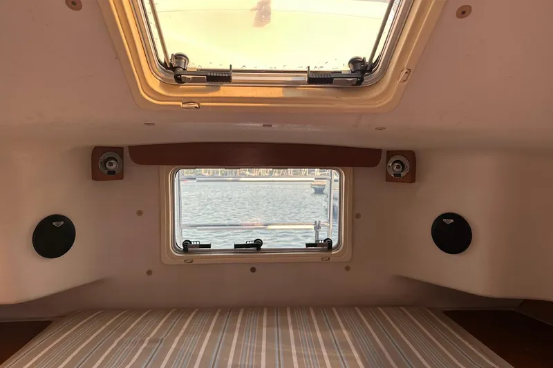 Slide: The Image of Interior cabin view of a 1997 Catalina Morgan 38 sailboat with window and speakers. - 60