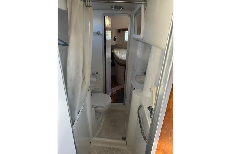 Slide: The Image of 1997 Catalina Morgan 38 yacht bathroom with shower, toilet, and sink. - 63