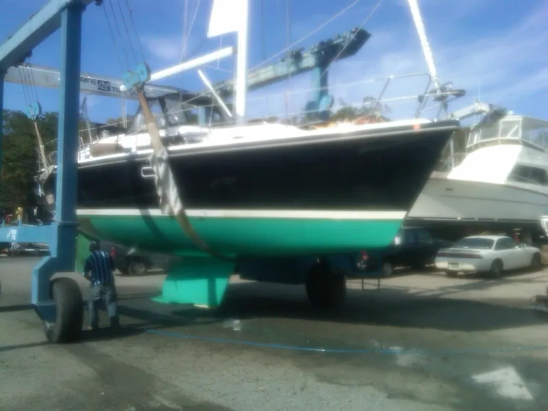 Slide: The Image of 1997 Catalina Morgan 38 sailboat in dry dock, lifted by crane for maintenance. - 7