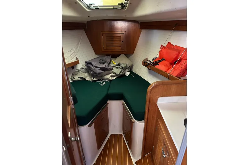 Slide: The Image of Cozy cabin interior of 1997 Catalina Morgan 38 sailboat with green cushions and life jackets. - 70