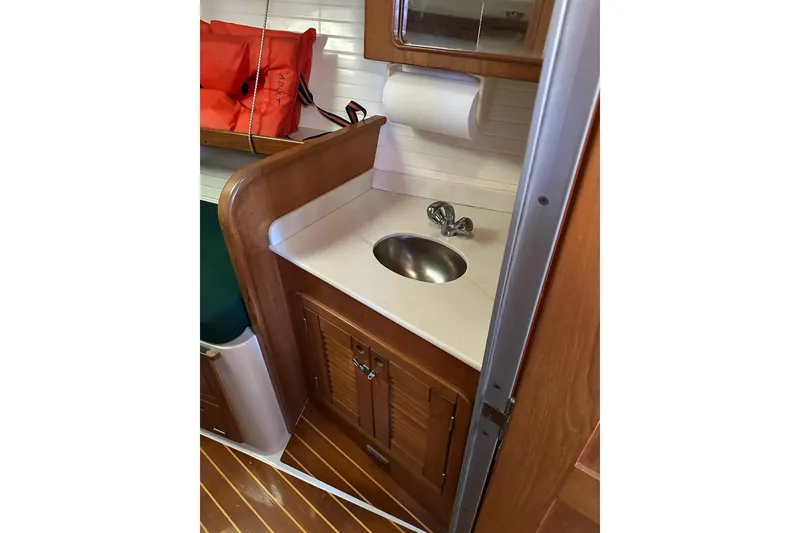 Slide: The Image of Interior of 1997 Catalina Morgan 38 sailboat with wooden cabinetry and compact sink area. - 73