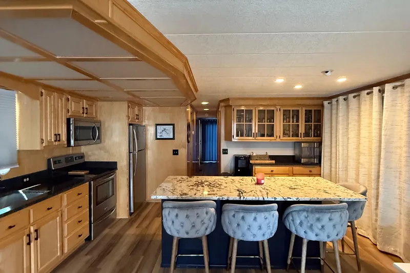 Slide: The Image of Luxurious 2003 Horizon houseboat kitchen with modern appliances and elegant marble island. - 10