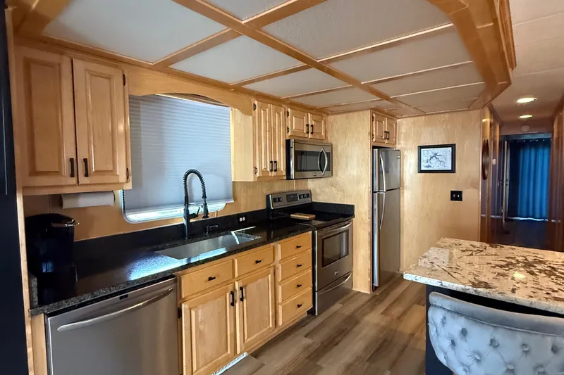 Slide: The Image of Modern kitchen interior in 2003 Horizon houseboat with wood cabinetry and stainless steel appliances. - 11