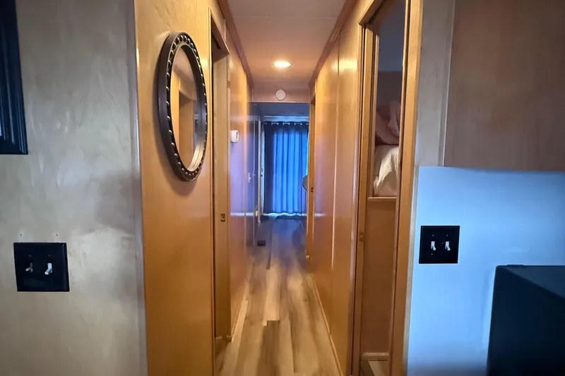 Slide: The Image of Hallway inside 2003 Horizon houseboat with wooden walls and flooring. - 16