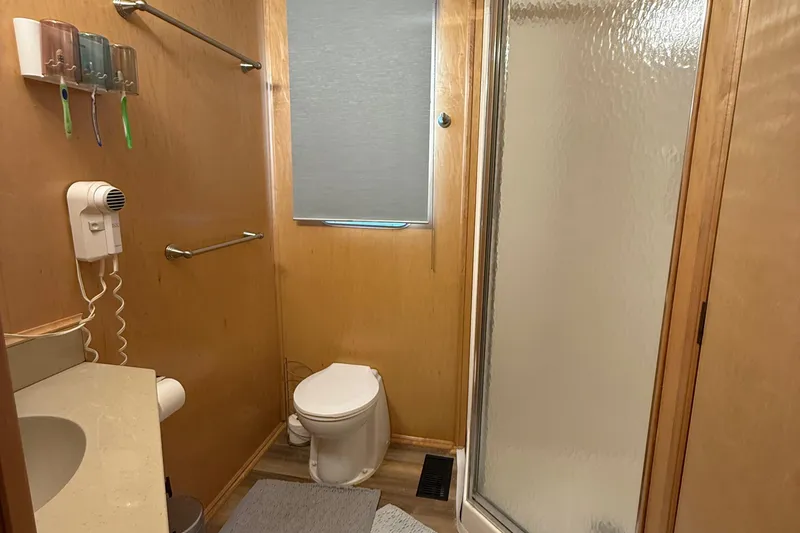 Slide: The Image of Compact bathroom in a 2003 Horizon houseboat with shower, toilet, and sink. - 18