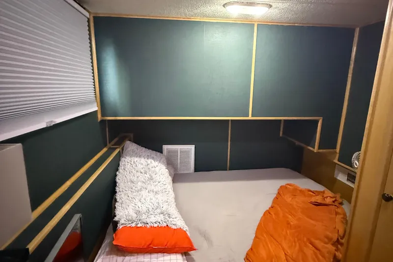 Slide: The Image of Cozy bedroom in 2003 Horizon houseboat with modern decor and vibrant bedding. - 20