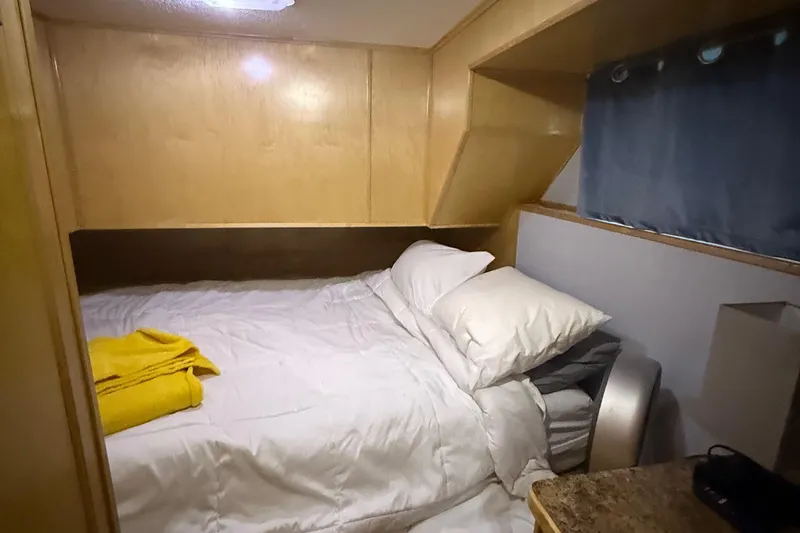 Slide: The Image of Cozy bedroom in 2003 Horizon houseboat with wooden paneling and comfortable bedding. - 21