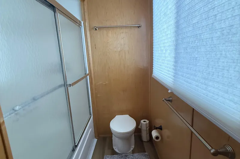Slide: The Image of Bathroom interior of 2003 Horizon houseboat with shower, toilet, and window blinds. - 26