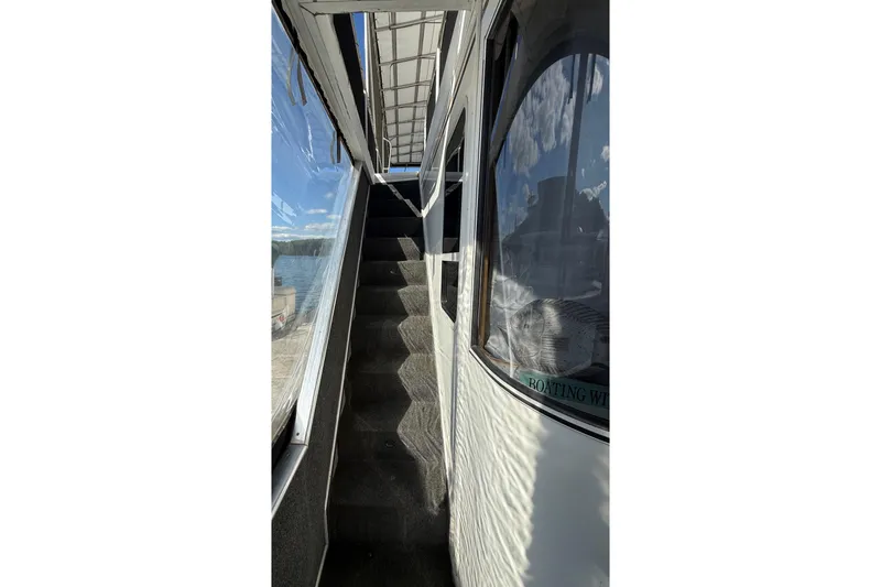 Slide: The Image of Staircase on 2003 Horizon houseboat with scenic lake view. - 27