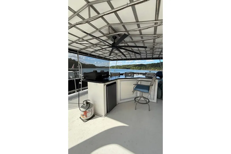 Slide: The Image of Houseboat deck with seating, fan, and scenic lake view, Horizon model 2003. - 29