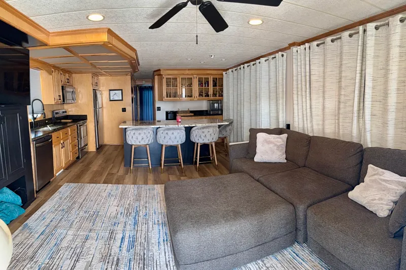 Slide: The Image of Interior of a 2003 Horizon houseboat with modern kitchen and cozy living area. - 5