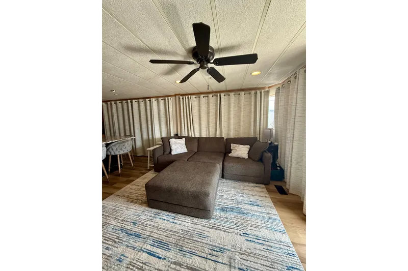 Slide: The Image of Cozy living area in 2003 Horizon houseboat with sectional sofa and ceiling fan. - 6