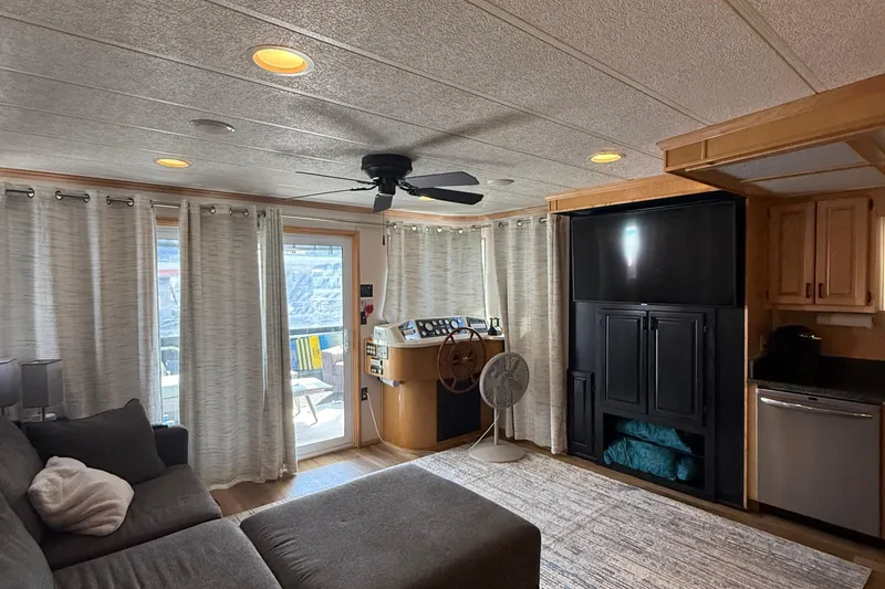 Slide: The Image of Interior of a 2003 Horizon houseboat with cozy living area and modern amenities. - 9