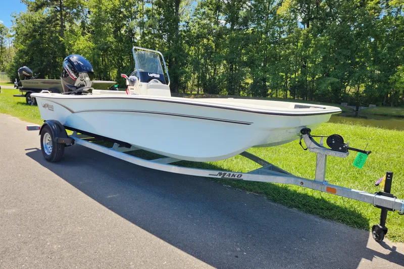 Slide: The Image of 2026 Mako Pro Skiff 17 CC boat on trailer, parked on a sunny day. - 1