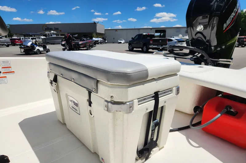 Slide: The Image of 2026 Mako Pro Skiff 17 CC boat with cushioned cooler seat and Mercury engine. - 10