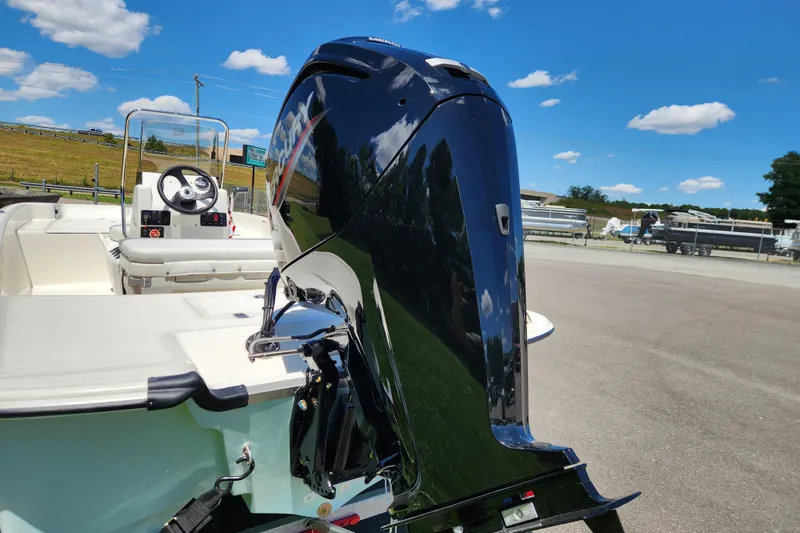 Slide: The Image of 2026 Mako Pro Skiff 17 CC with powerful outboard motor under clear blue sky. - 3