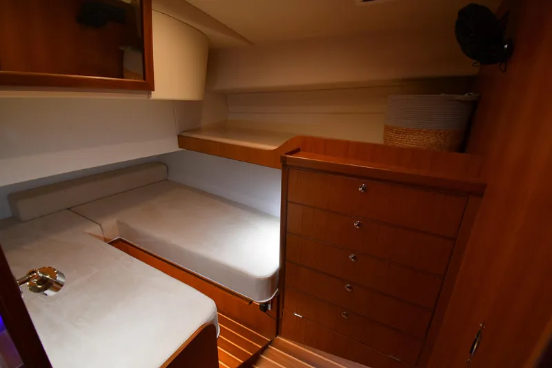 Slide: The Image of 2021 Hylas M44 yacht interior cabin with wooden cabinetry and cozy sleeping area. - 10