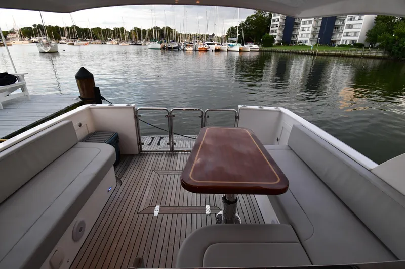 Slide: The Image of 2021 Hylas M44 yacht deck with seating and table, overlooking a marina. - 15