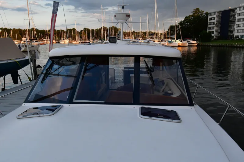 Slide: The Image of 2021 Hylas M44 yacht docked at marina, surrounded by sailboats and waterfront buildings. - 18