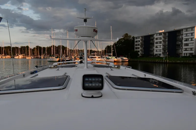 Slide: The Image of Front view of 2021 Hylas M44 yacht docked in a marina at sunset. - 19