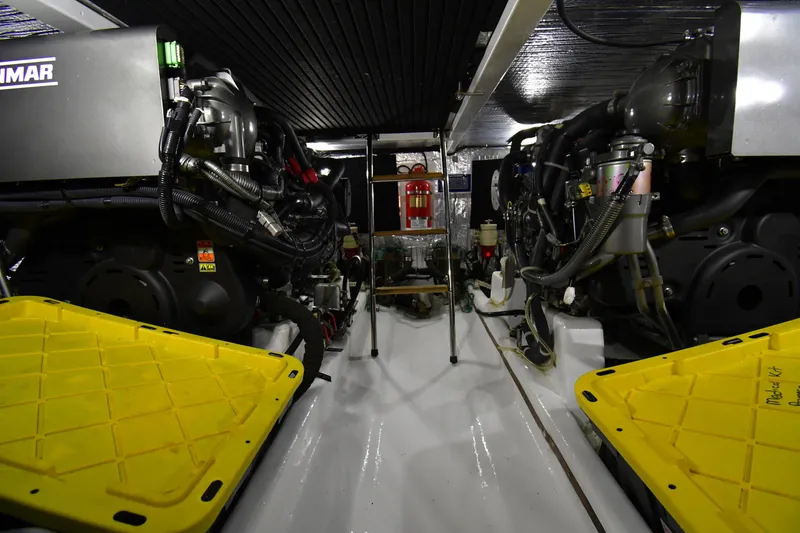 Slide: The Image of Engine room of 2021 Hylas M44 yacht, featuring dual Yanmar engines and safety equipment. - 22