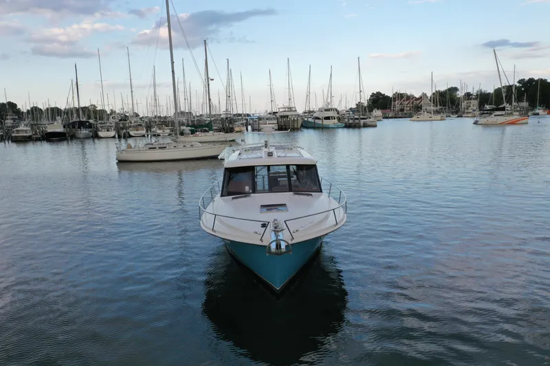 Slide: The Image of 2021 Hylas M44 yacht docked in a marina with sailboats and calm water. - 24