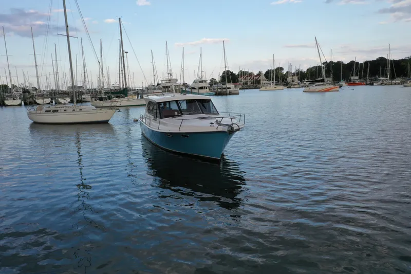 Slide: The Image of 2021 Hylas M44 yacht in a marina with sailboats and calm water. - 25
