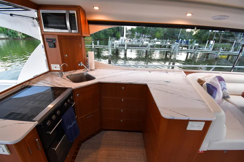 Slide: The Image of Luxurious kitchen interior of 2021 Hylas M44 yacht with marble countertops and scenic water view. - 4