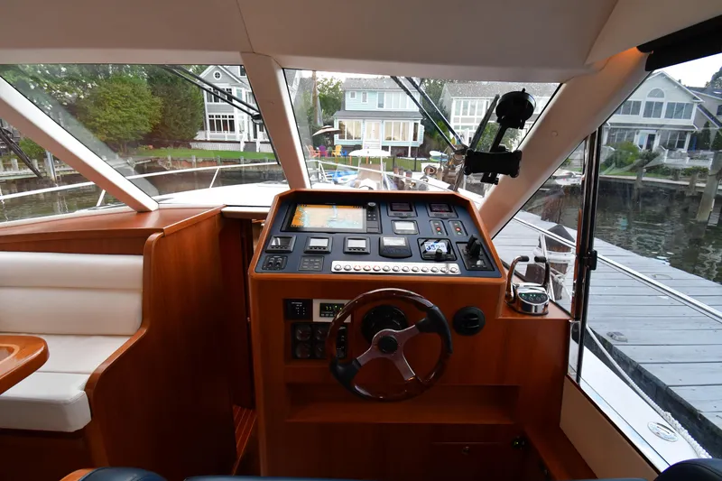 Slide: The Image of Interior view of 2021 Hylas M44 yacht helm with modern controls and waterfront background. - 6