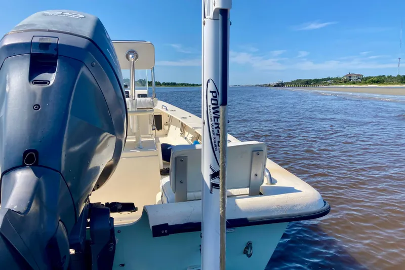 Slide: The Image of 2007 Jones Brothers 200 Bateau boat on calm water, featuring a powerful outboard motor. - 4