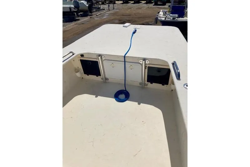 Slide: The Image of 2007 Jones Brothers 200 Bateau boat interior with storage compartments and blue rope. - 7