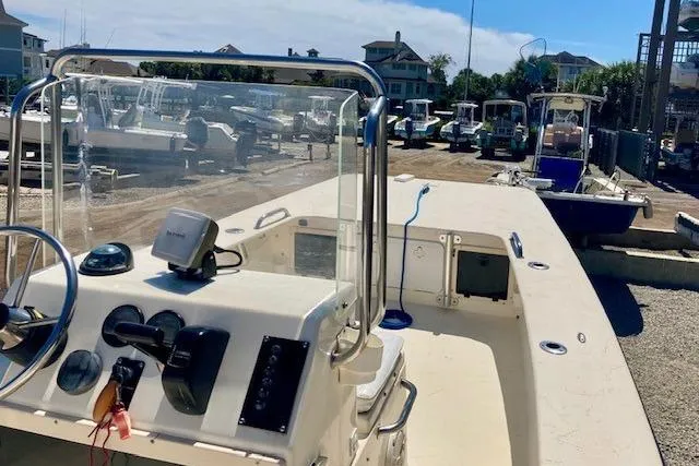 Slide: The Image of 2007 Jones Brothers 200 Bateau boat docked, featuring steering console and marina background. - 9