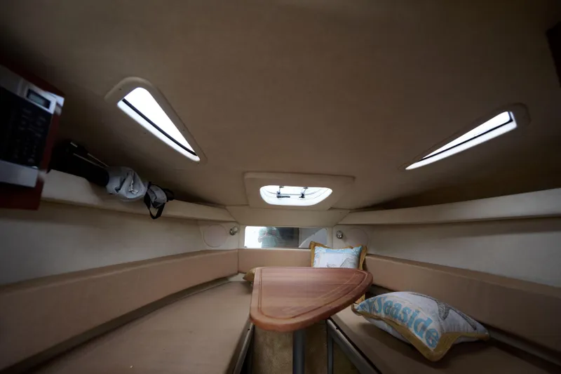 Slide: The Image of Interior cabin of 2011 Sea Ray 260 Sundancer with seating and cushions. - 16