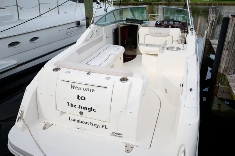 Slide: The Image of 2011 Sea Ray 260 Sundancer boat docked, featuring "Welcome to The Jungle" text. - 4