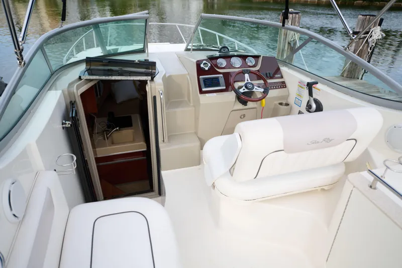 Slide: The Image of 2011 Sea Ray 260 Sundancer boat interior with helm, seating, and cabin entrance. - 9