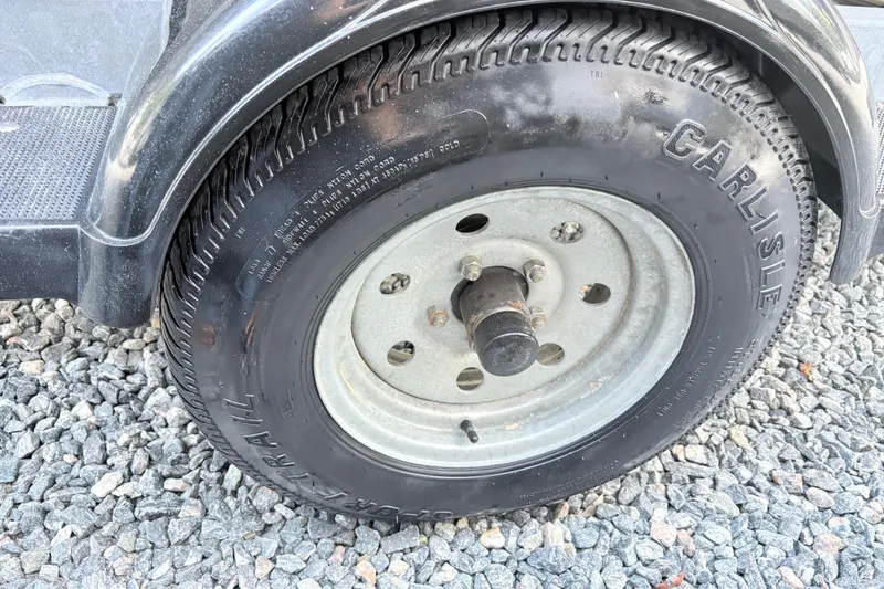 Slide: The Image of Trailer wheel of a 2014 Yamaha SX190 on gravel surface. - 15