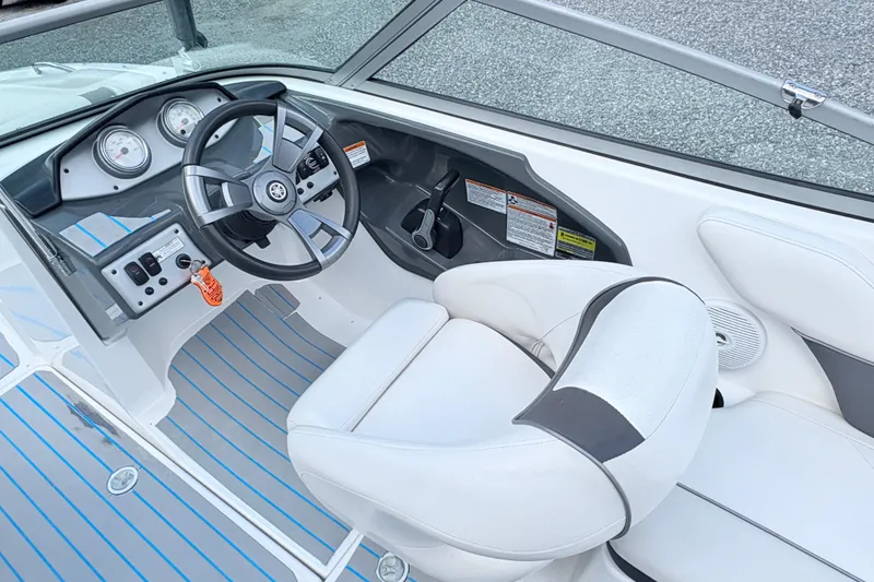 Slide: The Image of 2014 Yamaha SX190 boat cockpit with steering wheel and gauges, featuring white and gray interior. - 20